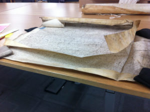 A parchment deed on a worktable at the National Archives, Kew